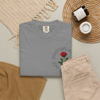 Gray graphic tee with red rose design, paired with beige pants and cozy accessories