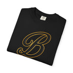 Black streetwear tee with bold gold letter B graphic, folded on white background