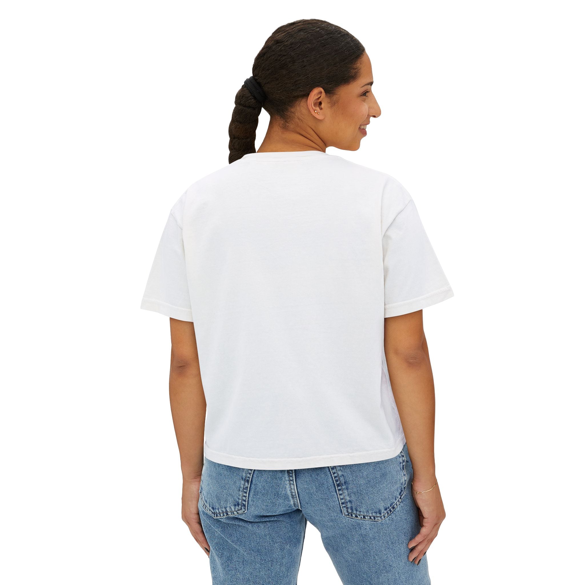 Woman wearing white graphic tee and blue jeans, back view, streetwear style