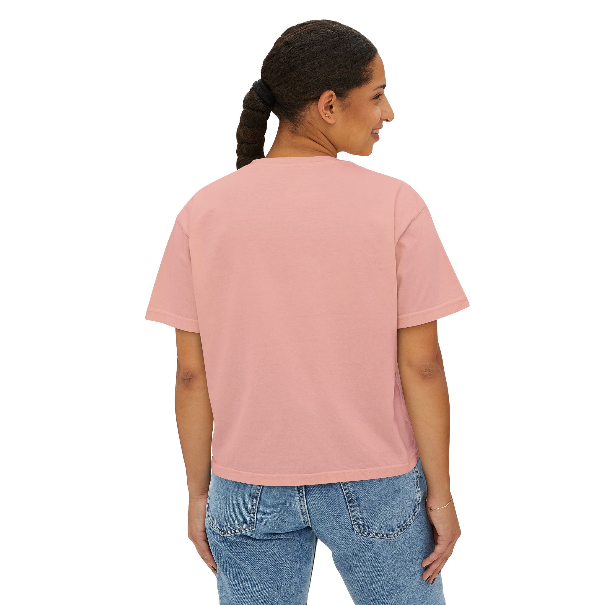 Woman wearing pink oversized graphic tee with jeans, streetwear style