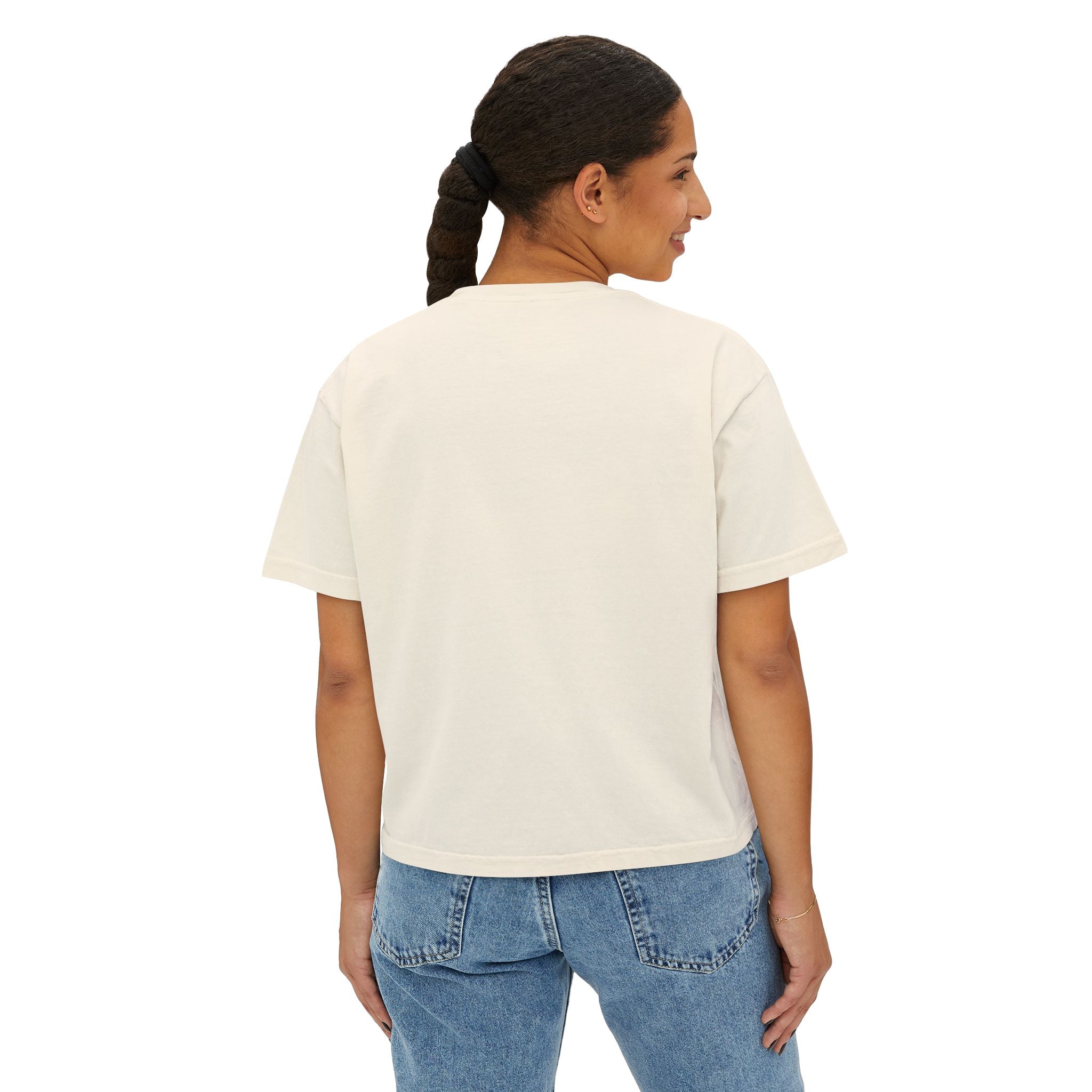 Cream oversized graphic tee paired with blue jeans, streetwear style