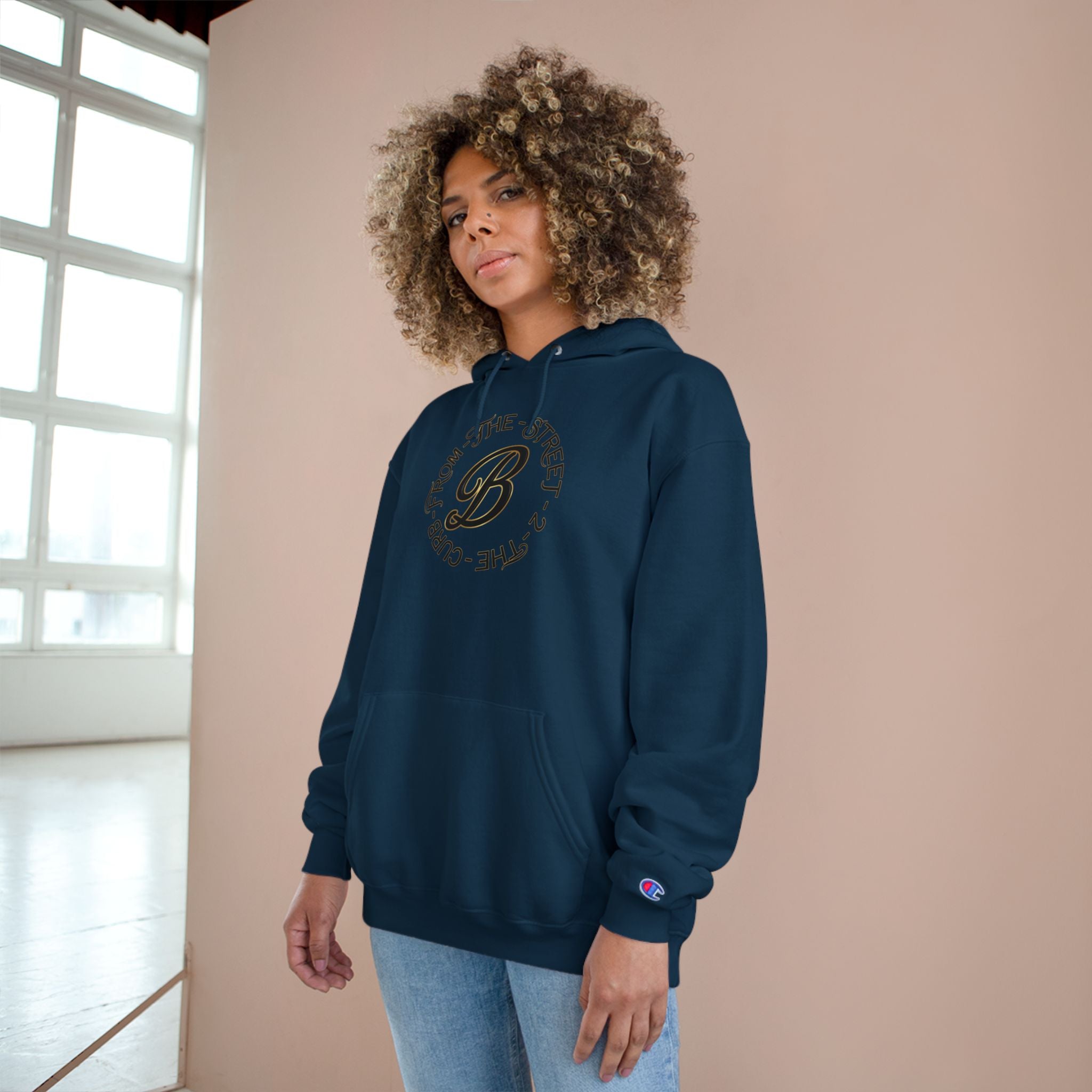Woman wearing navy hoodie with 'From The Street 2 The Curb' graphic, streetwear style