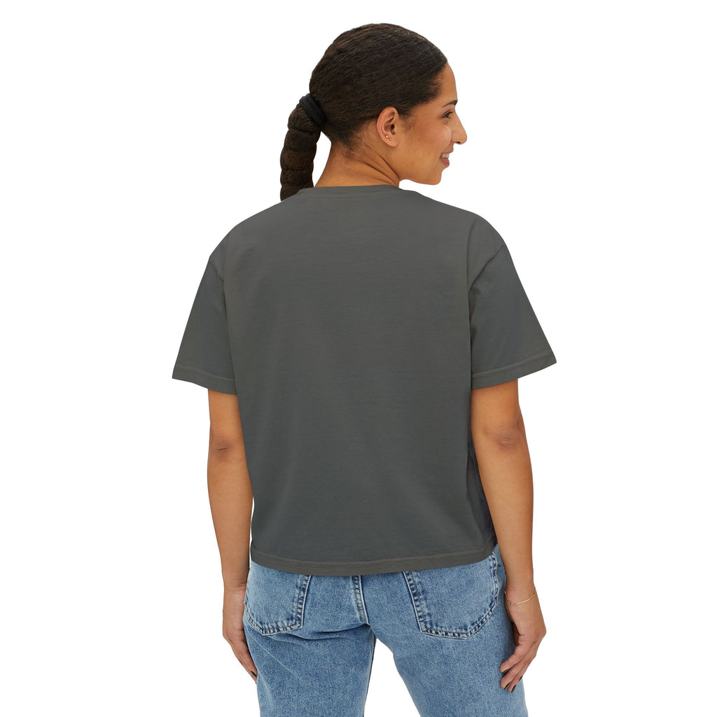 Woman wearing dark gray streetwear tee with blue jeans, back view
